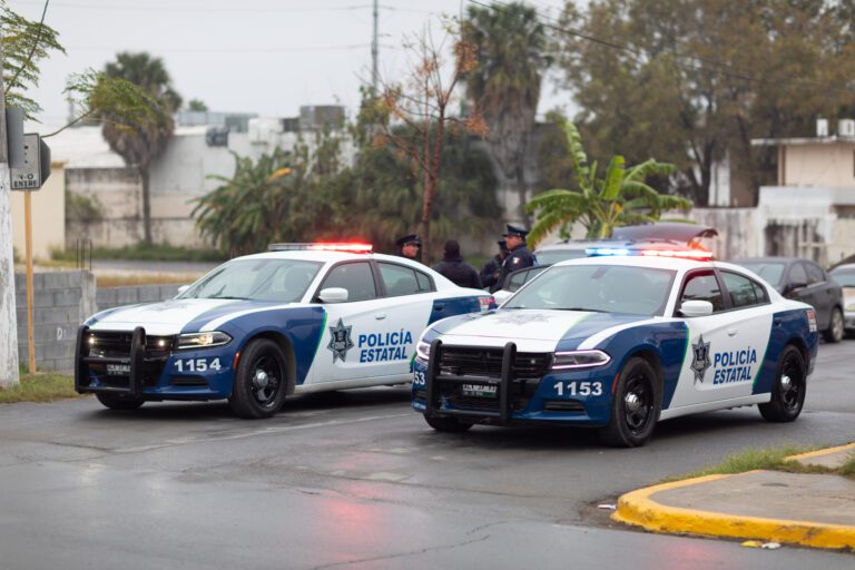 Matamoros, Tamaulipas, Mexico - November 20, 2018: Two Tamaulipas State Police cars, blocking a street in the city of Matamoros with their sirens on. policia